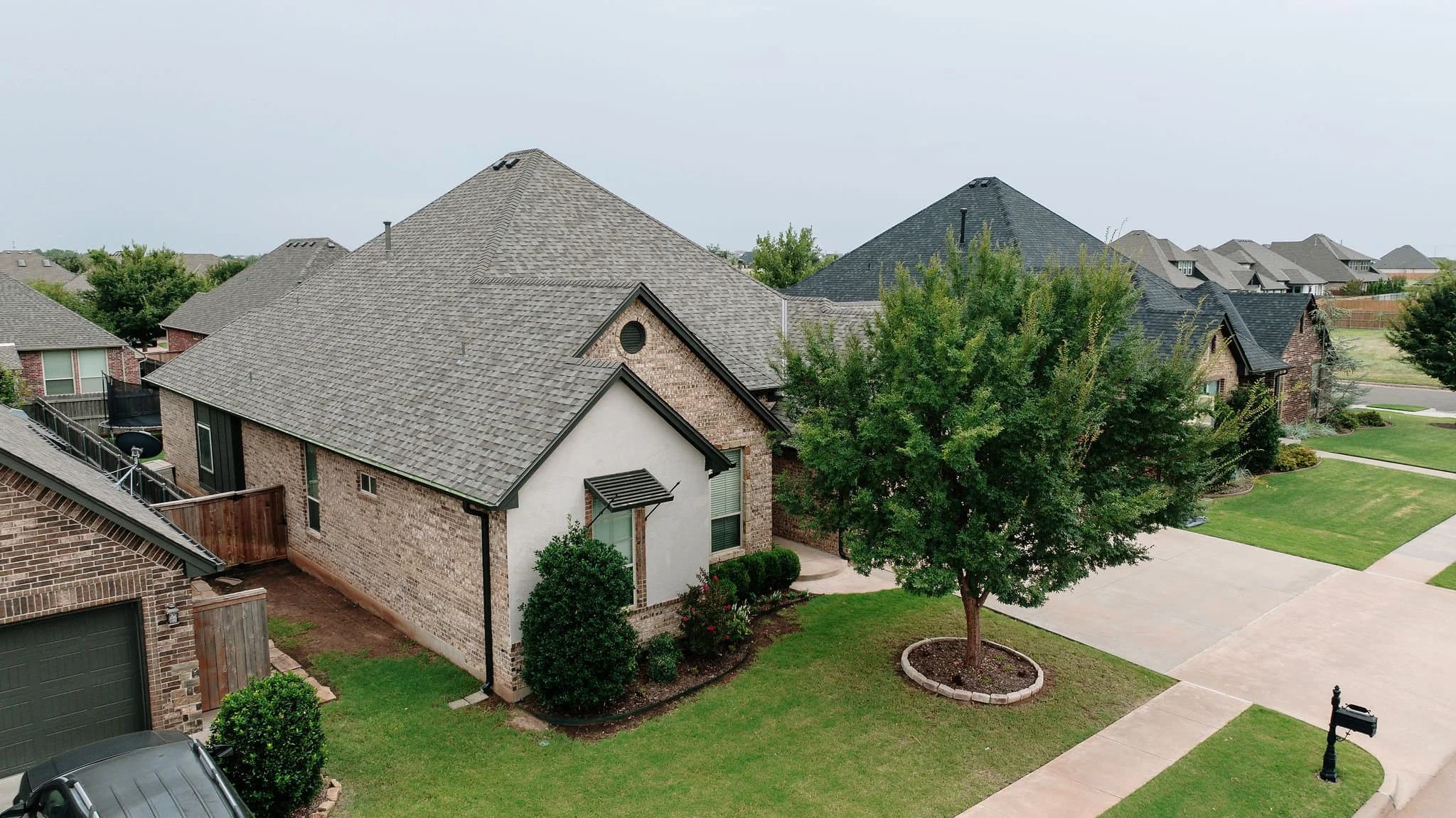 Completed residential roof in a Fort Worth neighborhood