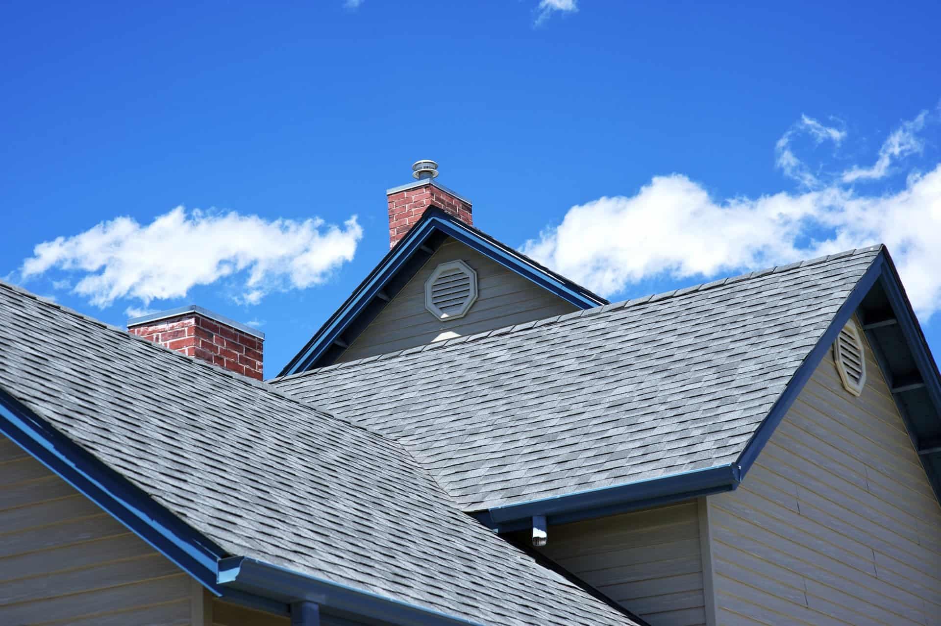 Roofing Fort Worth homes with a finished architectural shingle roof beneath a blue sky