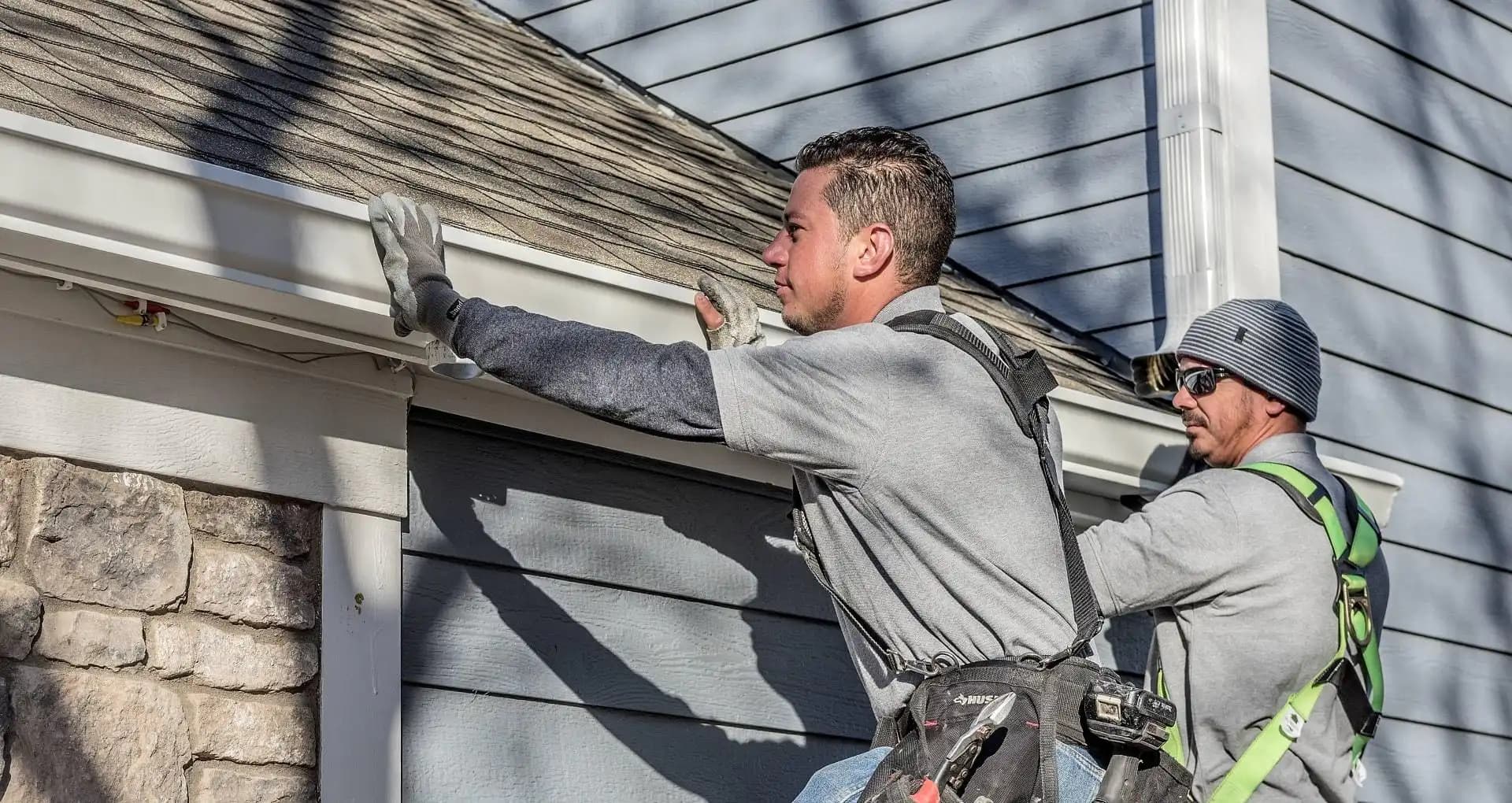 Roofers completing edge flashing work on a Fort Worth home