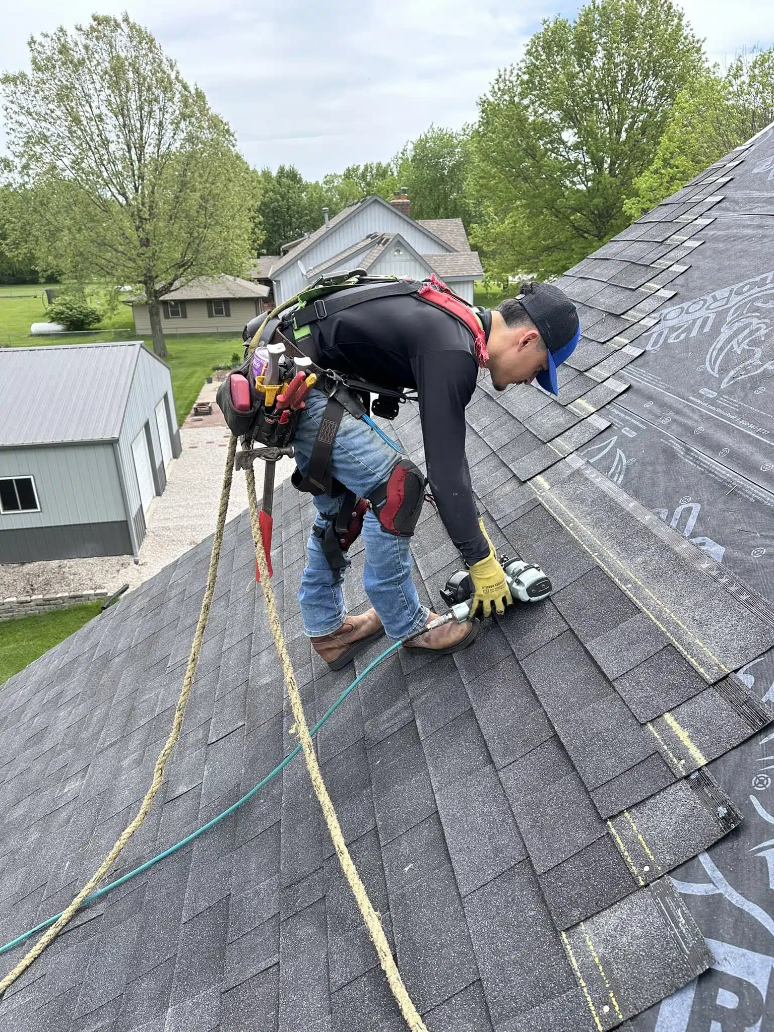Residential roofer working within a defined roof repair area